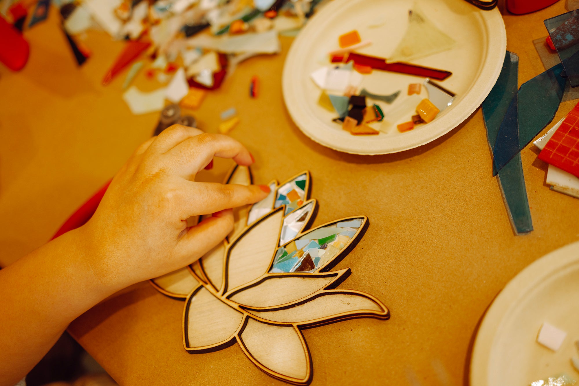 closeup-of-female-hand-making-a-mosaic-2023-06-27-22-52-55-utc.jpg